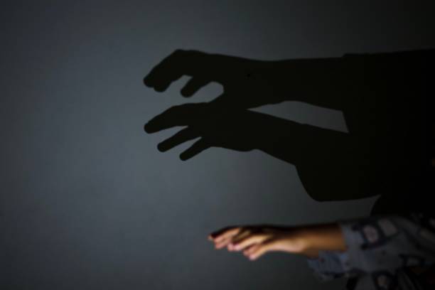 istock Asian young kid playing shadow on the wall 1186609732