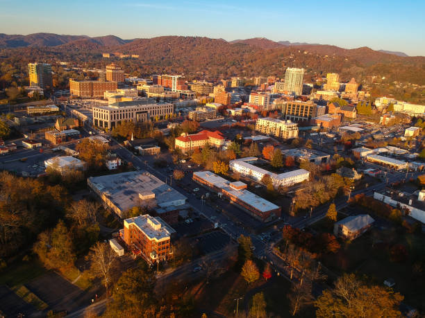 Downtown Asheville, North Carolina. Aerial drone view of the city in the Blue Ridge Mountains during Autumn / Fall Season.  Architecture, Buildings, Cityscape, Skyline, and forests. Southeast U.S. stock photo