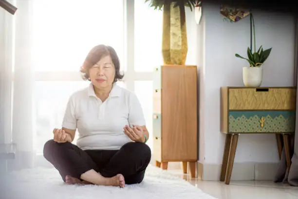 Photo of senior woman doing meditation