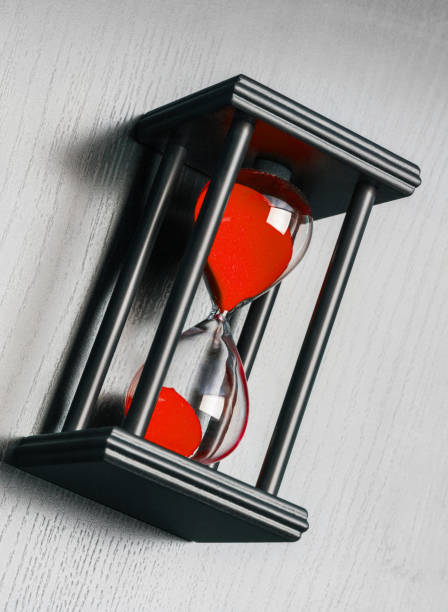istock Black hourglass on black background 1186615912