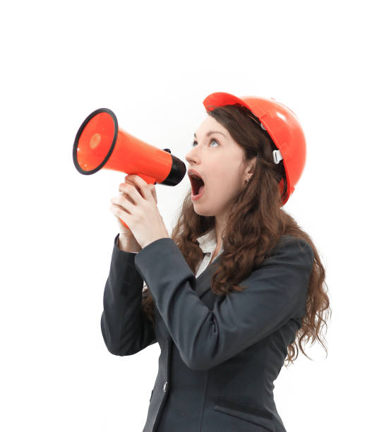 istock confident female architect - engineer shouts into a megaphone a megaphone. 1186616958