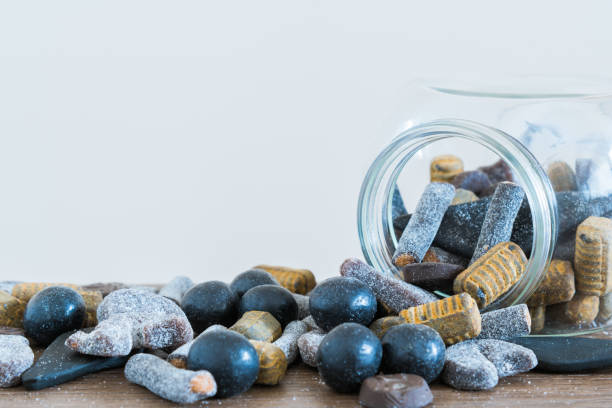 istock Jar lying on side with salmiakki spilling out onto table 1186618009