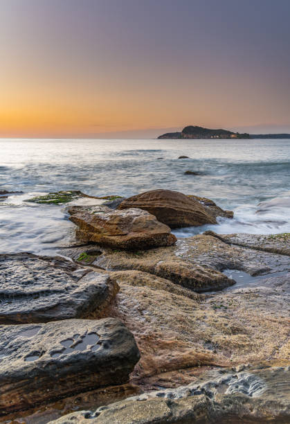 istock Clear Sky Rocky Sunrise Seascape 1186620935
