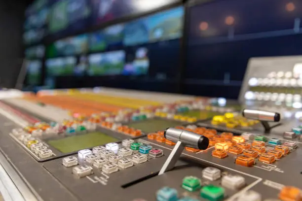 Professional broadcast video switcher used during live television productions, shallow depth of field.
