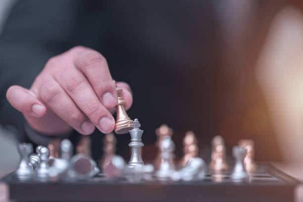 istock Business man holding golden king chess 1186624562