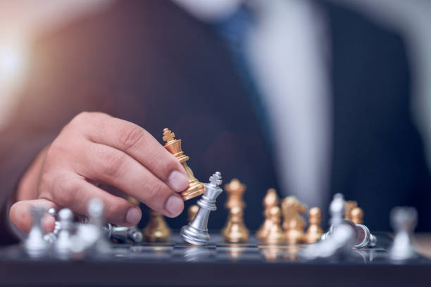 istock Business man holding golden king chess 1186624573
