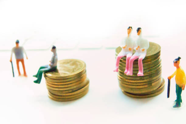 istock Man figurine standing on stack of coins - Elderly for the future concept 1186625355