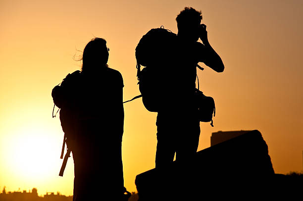 istock tourists at sunset 118663435