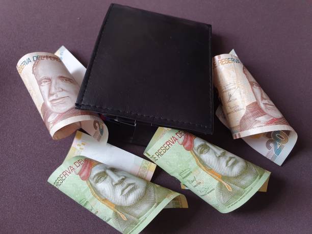 istock black leather wallet and peruvian banknotes of different denominations 1186634935