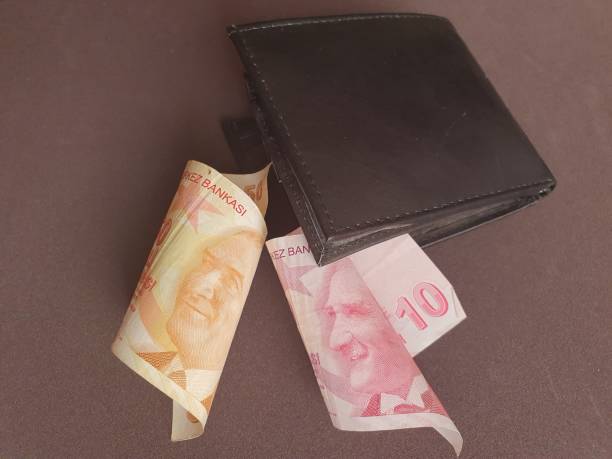 istock black leather wallet and Turkish banknotes of different denominations 1186636798