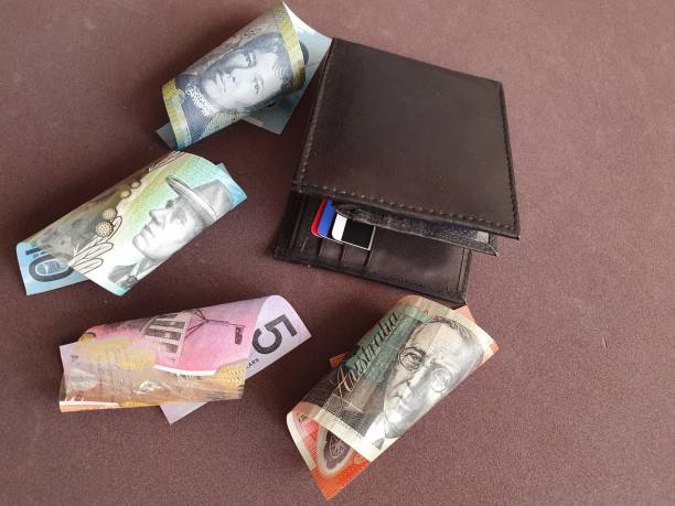istock black leather wallet and australian banknotes of different denominations 1186639005
