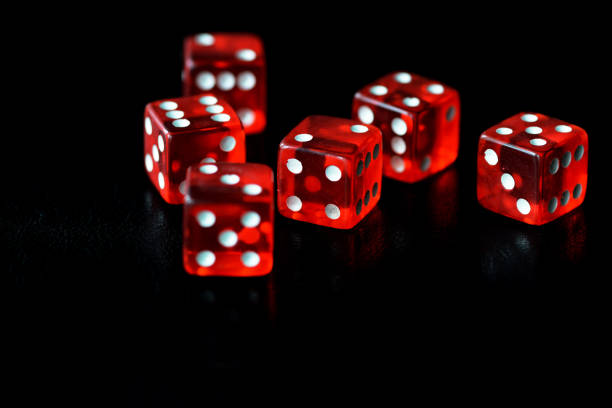 istock Red dice on a black background close-up. Gambling oncept 1186642788