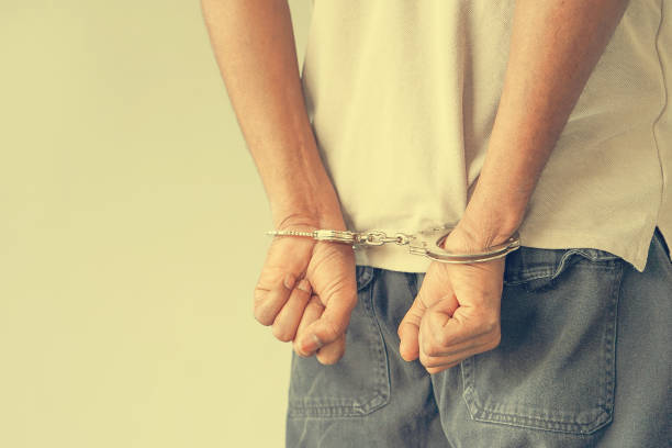 istock Criminal hands locked in handcuffs. Close-up view 1186644816