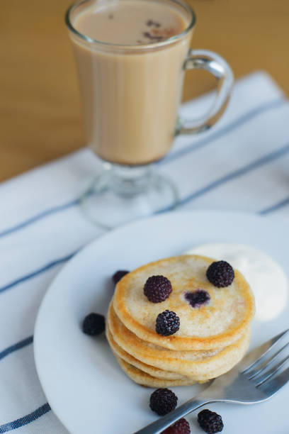 istock flapjack or pancakes with black raspberry with sour cream on dish and coffee 1186653022