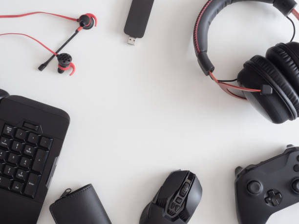 istock gamer work space concept, top view a gaming gear, mouse, keyboard, joystick, headset, mobile joystick, in ear headphone and mouse pad on black table background. 1186653061