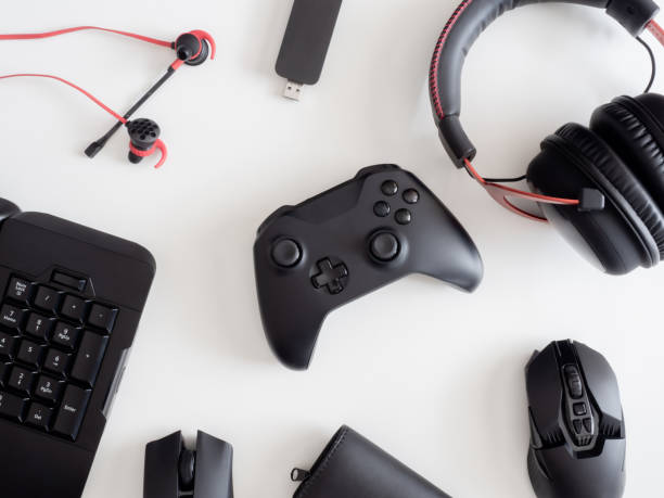 istock gamer work space concept, top view a gaming gear, mouse, keyboard, joystick, headset, mobile joystick, in ear headphone and mouse pad on black table background. 1186653080