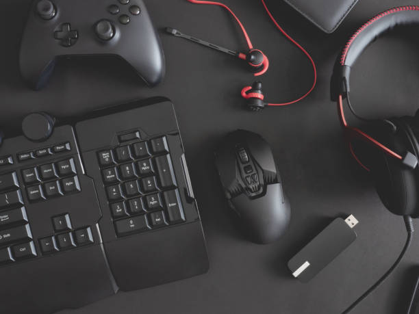 istock gamer work space concept, top view a gaming gear, mouse, keyboard, joystick, headset, mobile joystick, in ear headphone and mouse pad on black table background. 1186653113