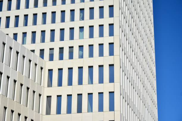istock Modern office building detail. Perspective view of geometric angular concrete windows on the facade of a modernist brutalist style building. 1186654450
