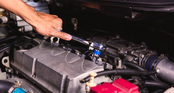 istock Hand of auto mechanic technician service engine and using wrench socket repairing car 1186658164