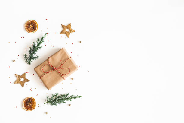 istock Christmas composition. Gift box, fir tree branches, golden decorations on white background. Christmas, winter, new year concept. Flat lay, top view, copy space 1186658951