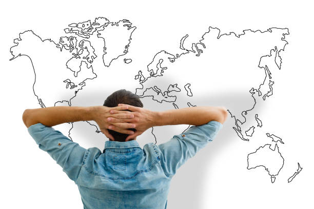 istock Businessman leaning back looking at world map 1186660498