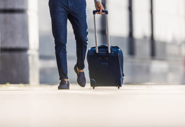 istock Unrecognizable businessman pulling his suitcase on the street. 1186663424