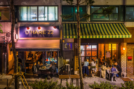 Local people enjoying the warm night air at al fresco restaurants and bars in the heart of Seoul, South Korea’s vibrant capital city.