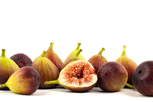 fig fruits and one cut figs on white background.