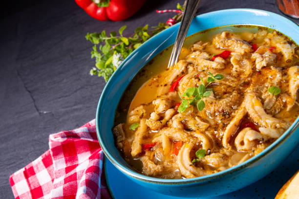 flaczki - fresh and spicy tripe soup with herbsSpicy tripe soup with red paprika.