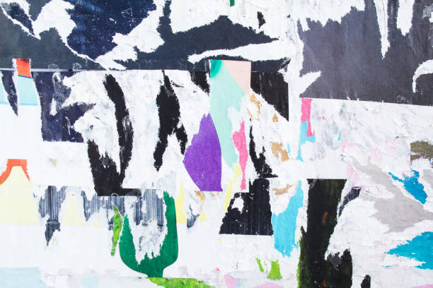 istock Dirty street billboard with old torn peeling paper posters. 1186665801
