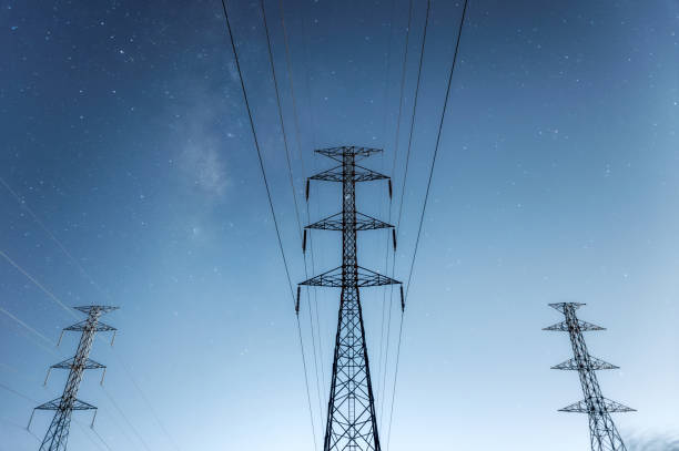 istock High voltage electricity pylon at night. 1186667173