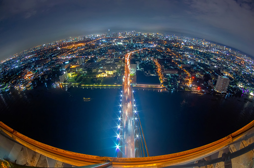 The top view of Rama 8 Bridge, one of Thailand's most famous bridges, which spans the Chao Phraya River at dusk.