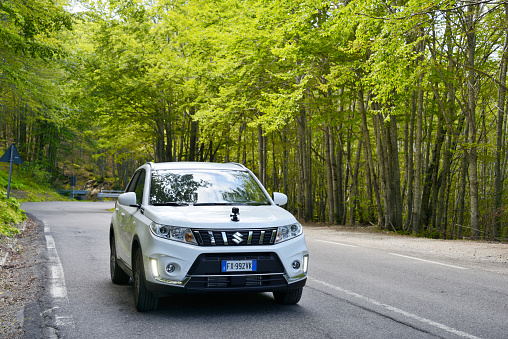 Abetone, Tuscany, Italy - August/6/2019: new Suzuki Vitara 2019 on mountain road. A GoPro Hero7 attached on the vehicle hood.