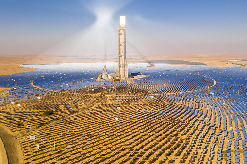 Solar power tower and mirrors that focus the sun's rays upon a collector tower to produce renewable, pollution-free energy, Aerial image.