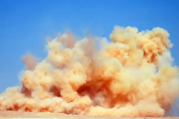 Dust storm after detonator blast on the mining site