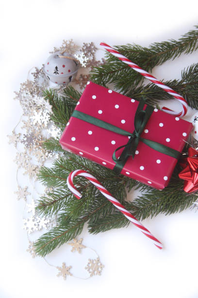 istock Christmas red gift box with green ribbon on white 1186670968