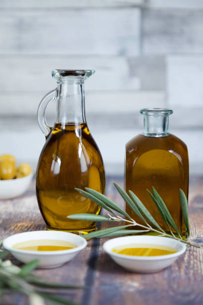 istock two oil bottles and olive leaves close-up 1186671831