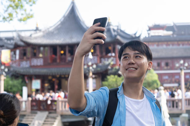 istock young asian man selfie with mobile phone 1186673205