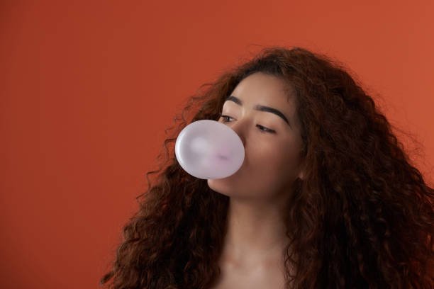istock Teenager blowing bubble gum ball 1186673227