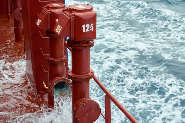 View of ballast water exchange process onboard of a ship using flow-through method underway in open ocean. Overflow method through ballast tank air head. Ballast Water exchange Management and Treatment concept.