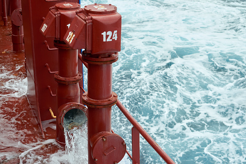 View of ballast water exchange process onboard of a ship using flow-through method underway in open ocean. Overflow method through ballast tank air head. Ballast Water exchange Management and Treatment concept.