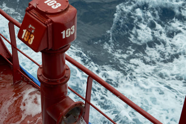 View of Ballast Water exchange process onboard of a ship using flow-through method underway in open ocean. Overflow method through ballast tank air head. View of ballast water exchange process onboard of a ship using flow-through method underway in open ocean. Overflow method through ballast tank air head. Ballast Water exchange Management and Treatment concept. ballast water stock pictures, royalty-free photos & images