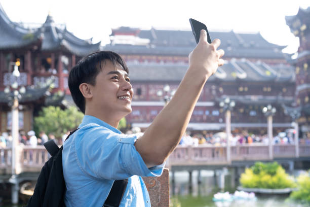 istock young asian man selfie with mobile phone 1186673424