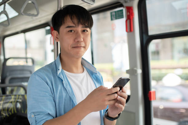 istock young asian man using smart phone on bus 1186673715