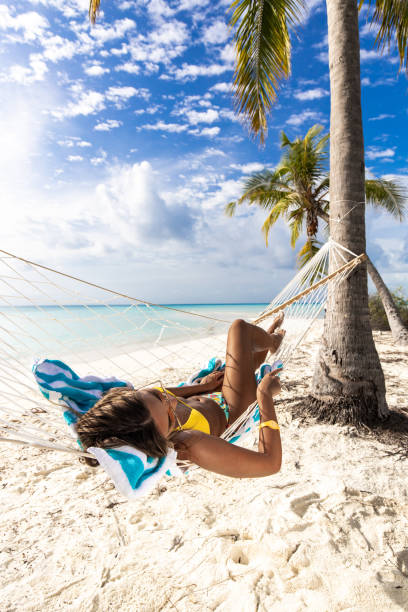 istock Relaxed woman spending a summer day in hammock on the beach. 1186674654