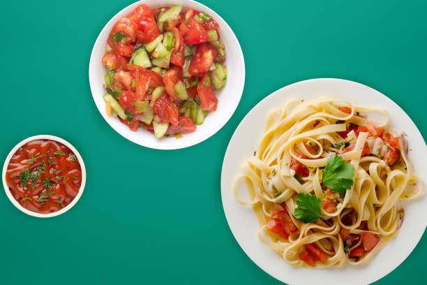 istock spaghetti on a white plate. spaghetti tomatoes, onions, cabbage on a colored background. healthy food 1186674800