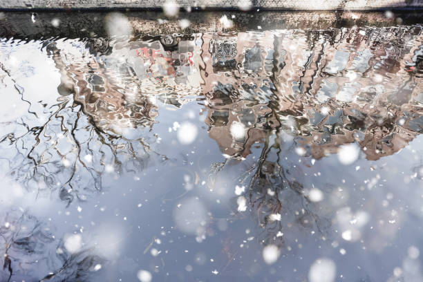 House reflection in the canal of Delft House and bridge reflections in the canal of Delft. Pastel trendy toning. Beautiful inspiring moody faded scenery delft winter netherlands snow stock pictures, royalty-free photos & images
