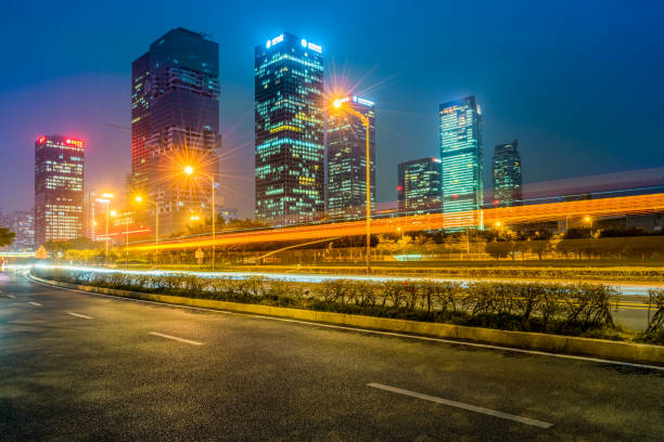 the light trails on the modern building background - office building car industrial district business imagens e fotografias de stock