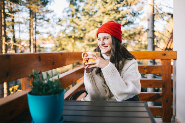 istock Woman drinking tea on balcony 1186686157