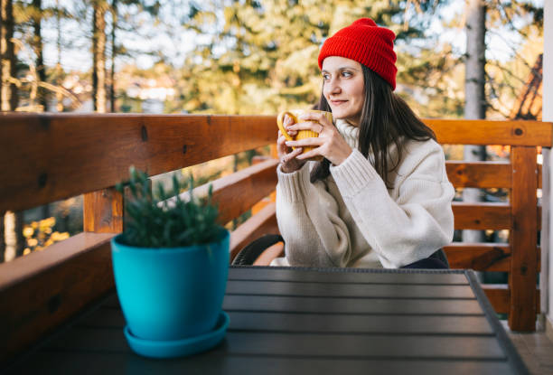 istock Woman drinking tea on balcony 1186686227